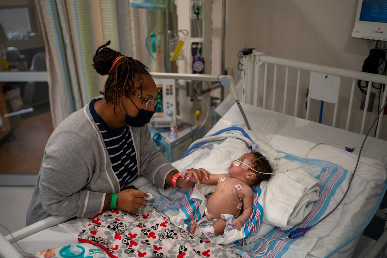 Catherine Perrilloux holds the hand of her two-month-old baby, Carvase Perrilloux. 