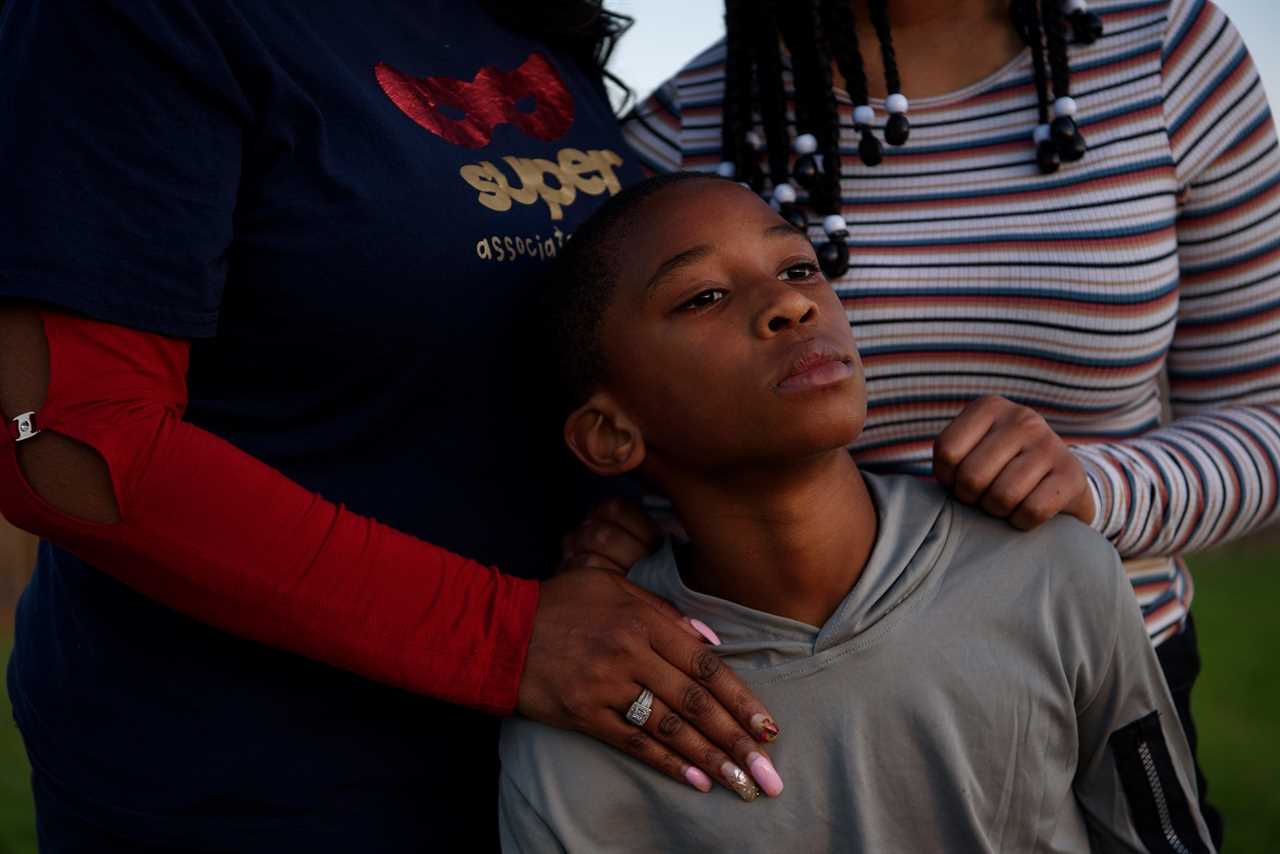 FRESNO, TX &acirc; OCTOBER 29, 2021: Adin James, 8, poses for a portrait alongside his sister, Madison, 16, and his mother, Ebony, 50, following the death of his father, Terrence James, who died after becoming ill with COVID-19, in Fresno, Texas.