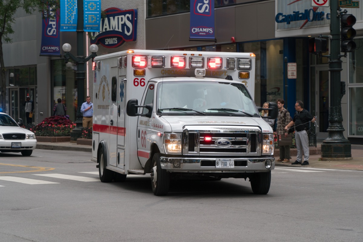 Chicago PD ambulance rushing through downtown intersection towards emergency