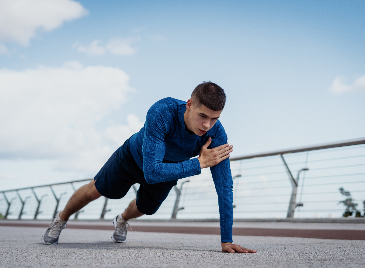 man doing plank shoulder tap exercise to look and feel younger