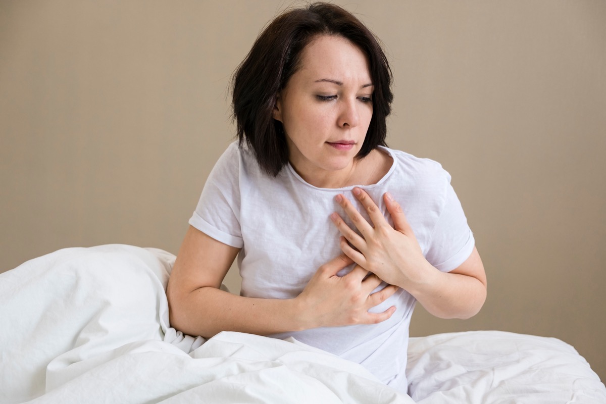 Woman is clutching her chest