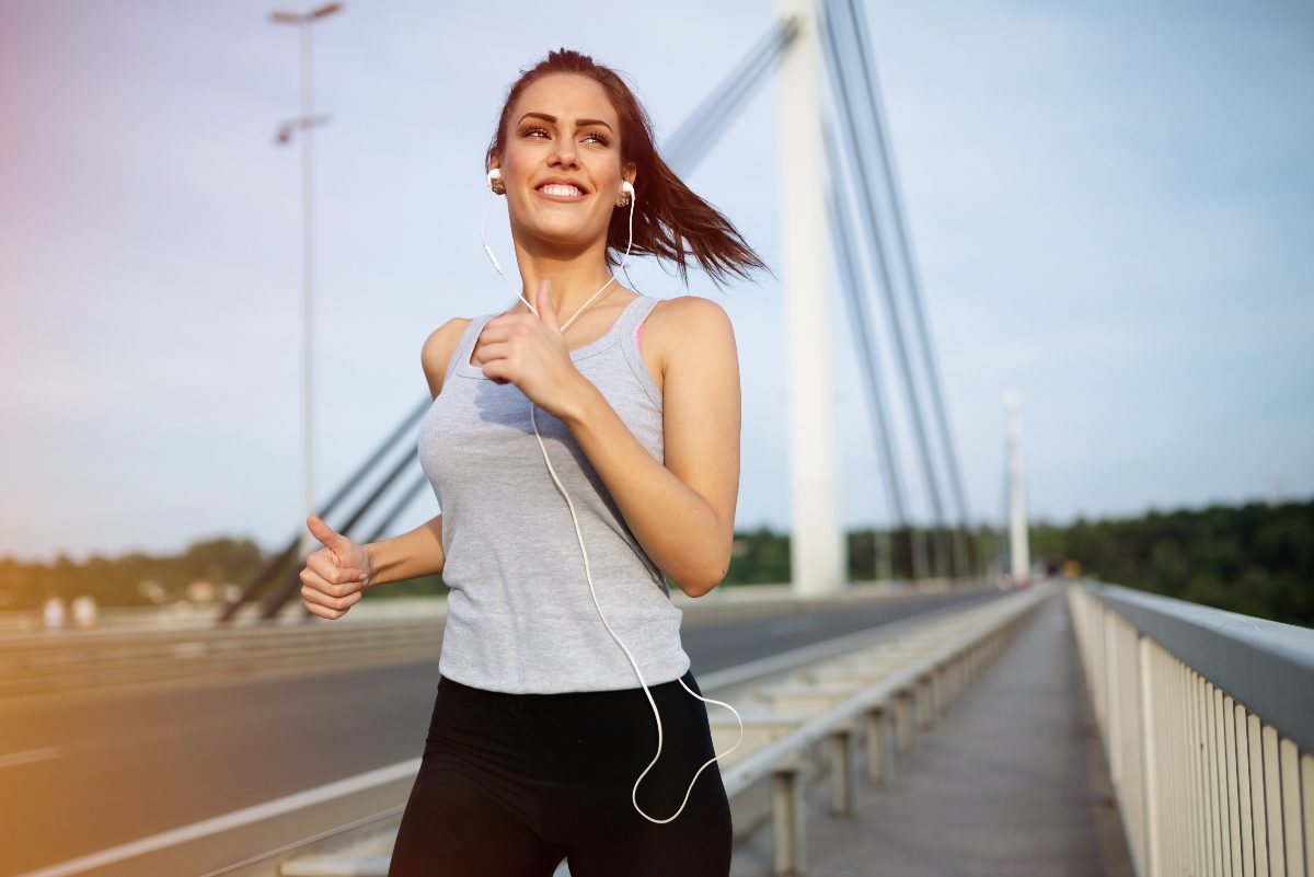 woman jogging on bridge