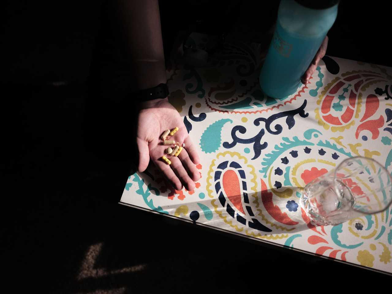 Ayden Varno holding a handful of pills