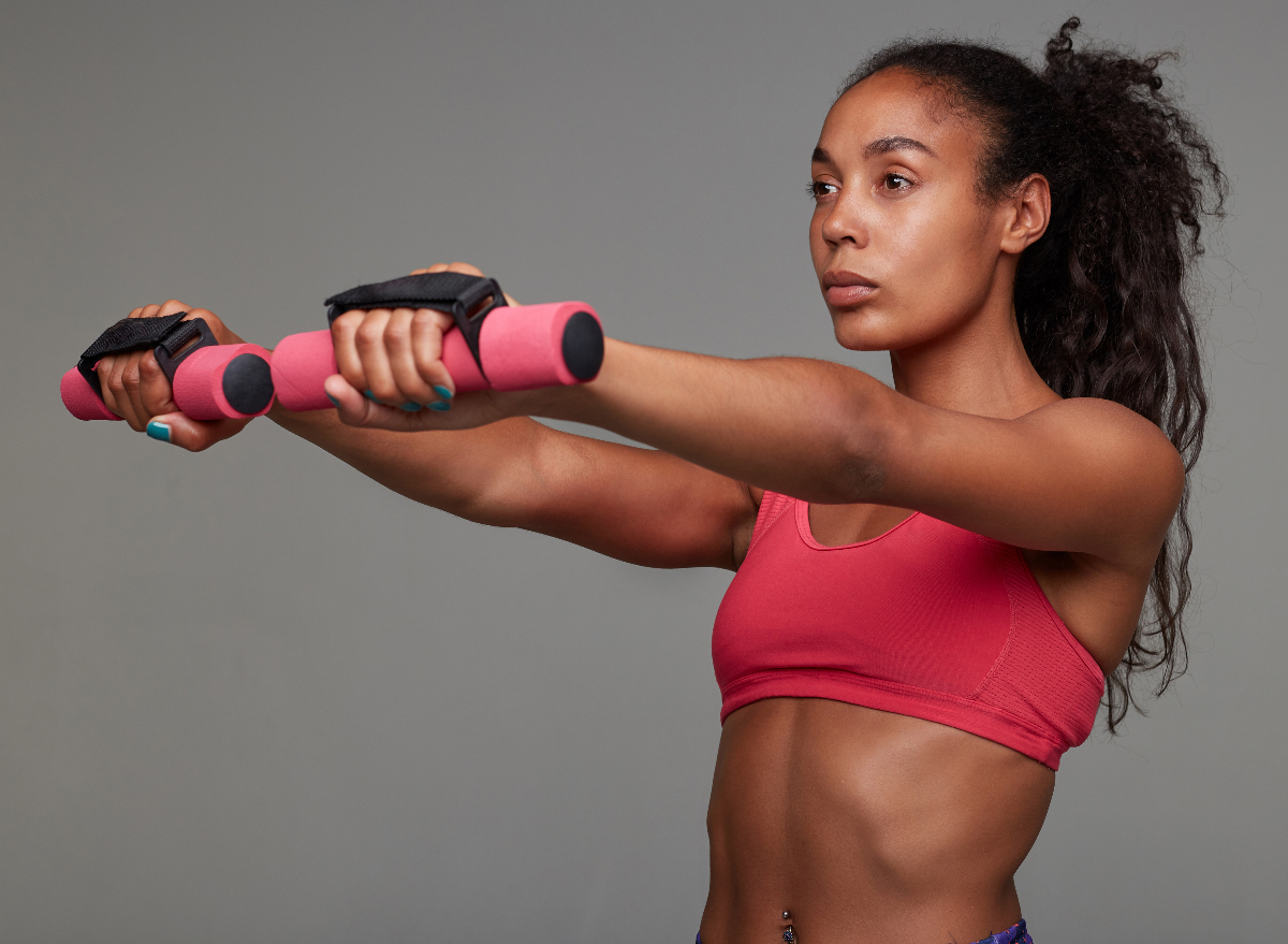 woman performing dumbbell front raise