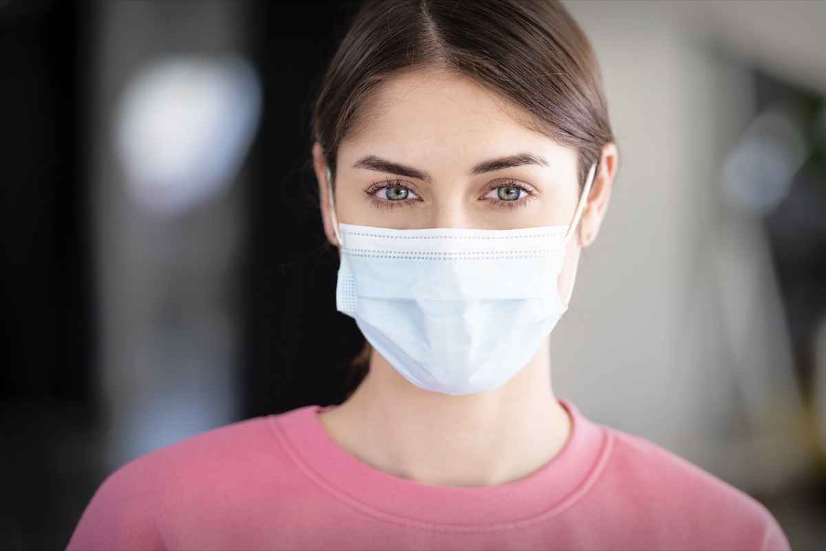 Young woman close-up portrait while wearing face mask.