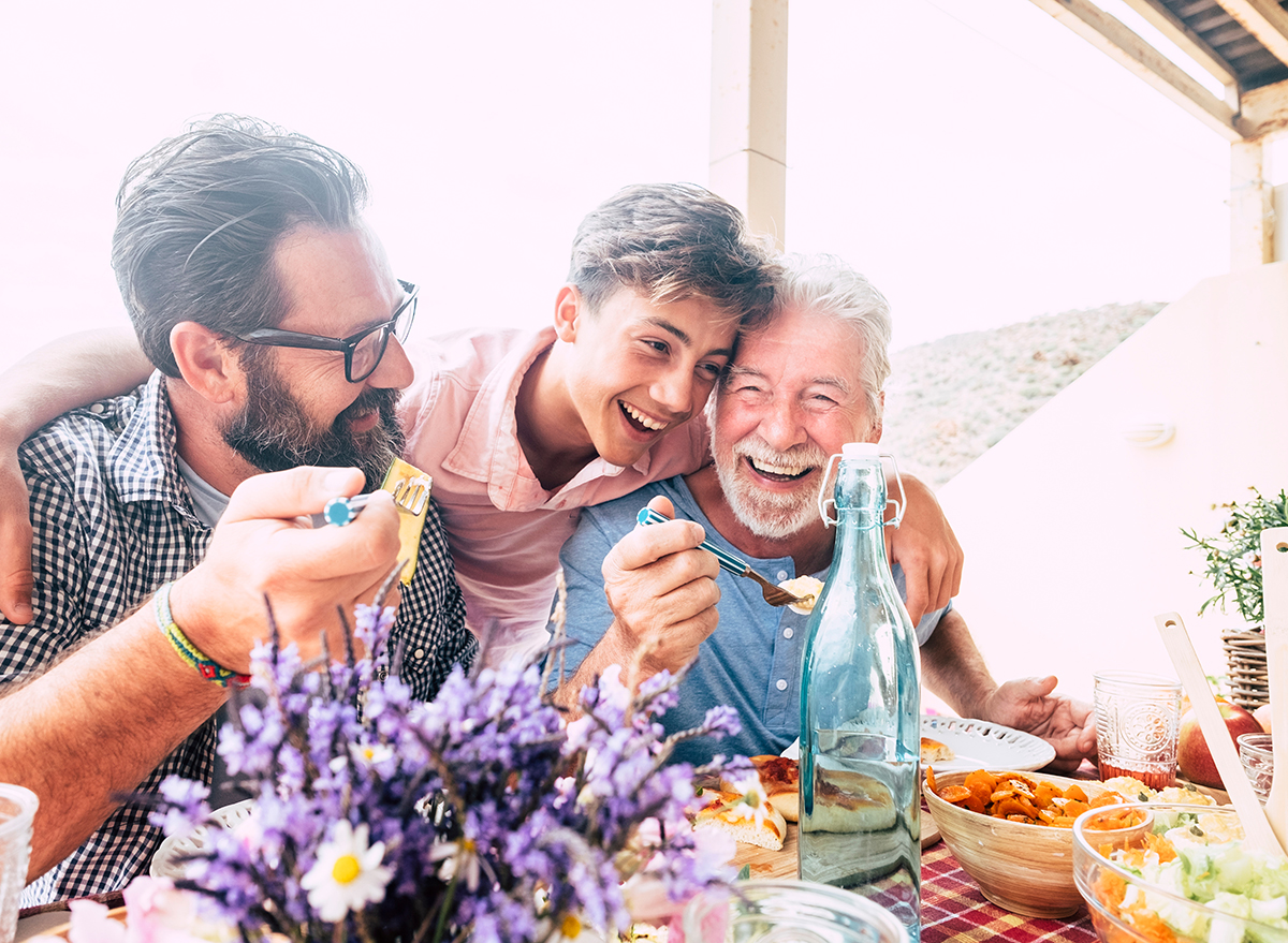 family hugging, laughing outside dinner