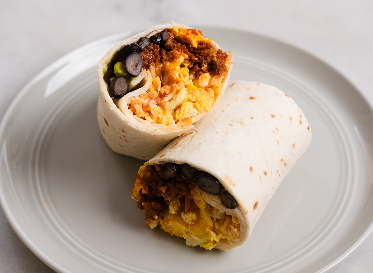 breakfast burrito cut in half on a plate ready to eat