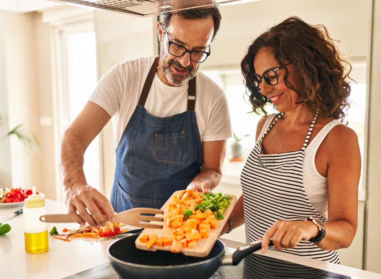 couple cooking healthy meal, demonstrating ways to stay healthy without exercising