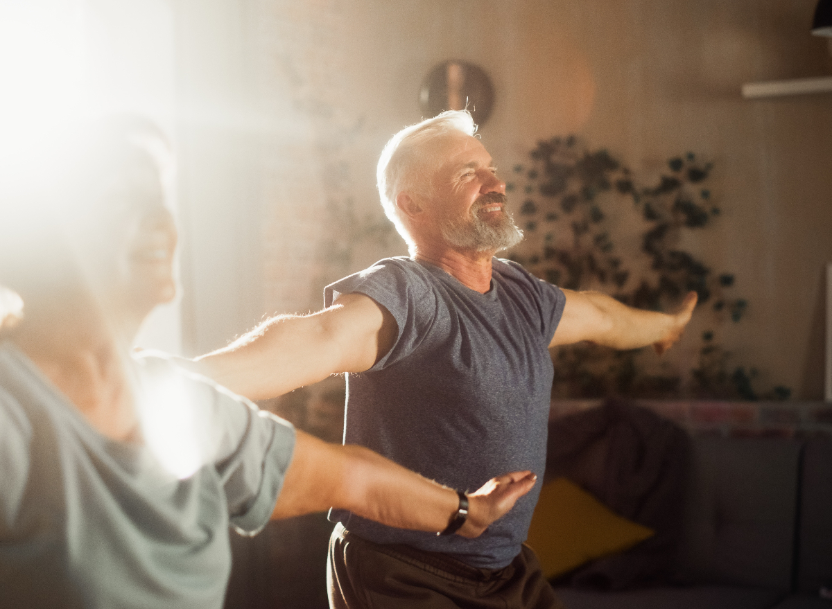 mature couple doing jumping jacks