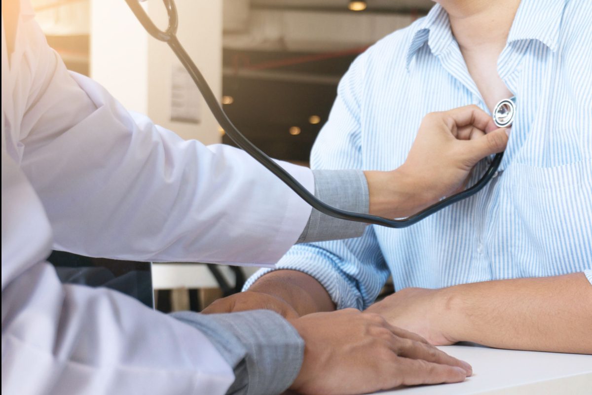 doctor checking someone's heart with a stethoscope