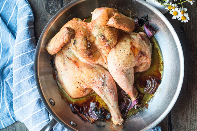 Roasted spatchcocked chicken in a large skillet