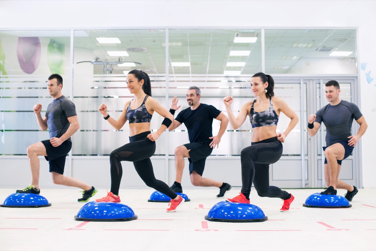 Group of people doing lange exercise on bosu ball.