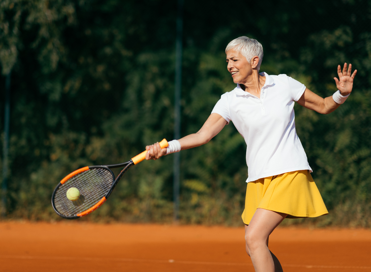 mature woman playing tennis, worst exercises for arthritis