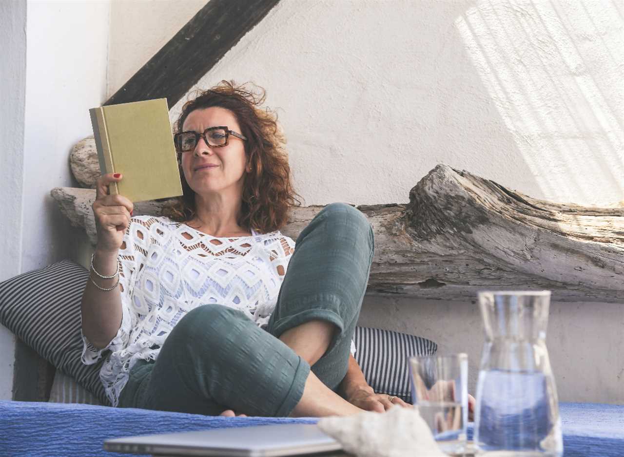 woman reading book outdoors