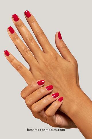 Manicured hands with red nail polish