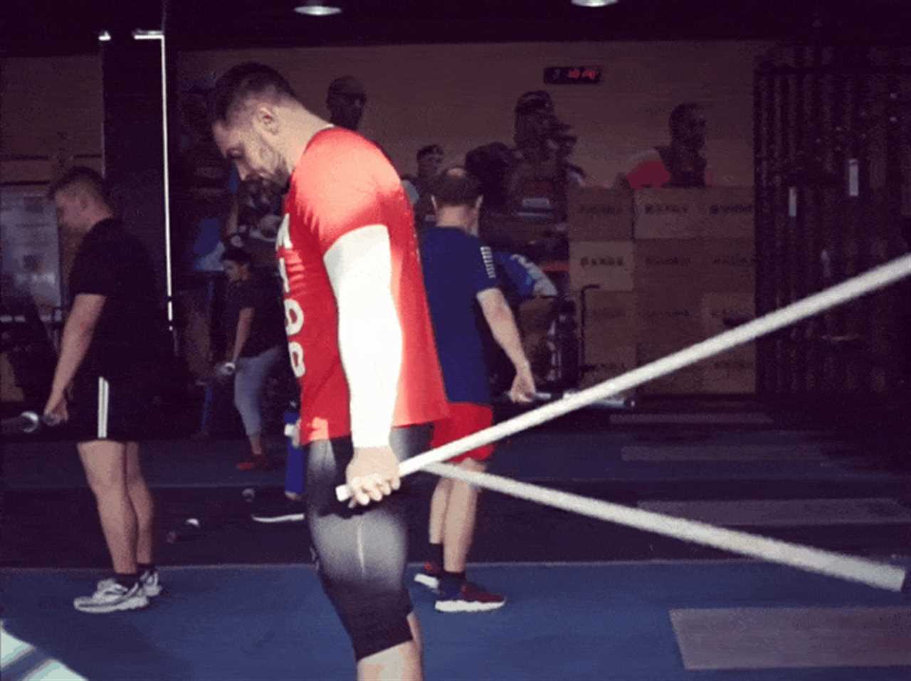 Someone doing wrist mobility exercises with pvc pipe. 