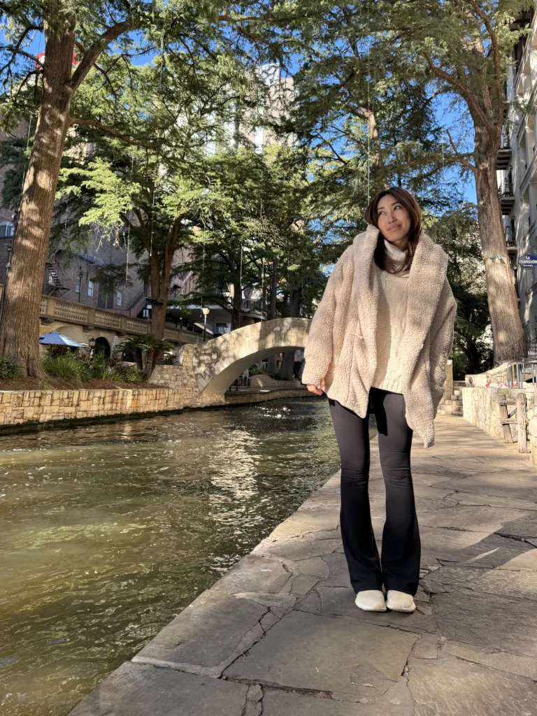 cassey ho blogilates wearing popflex cocoon coat taupe with flared leggings riverwalk