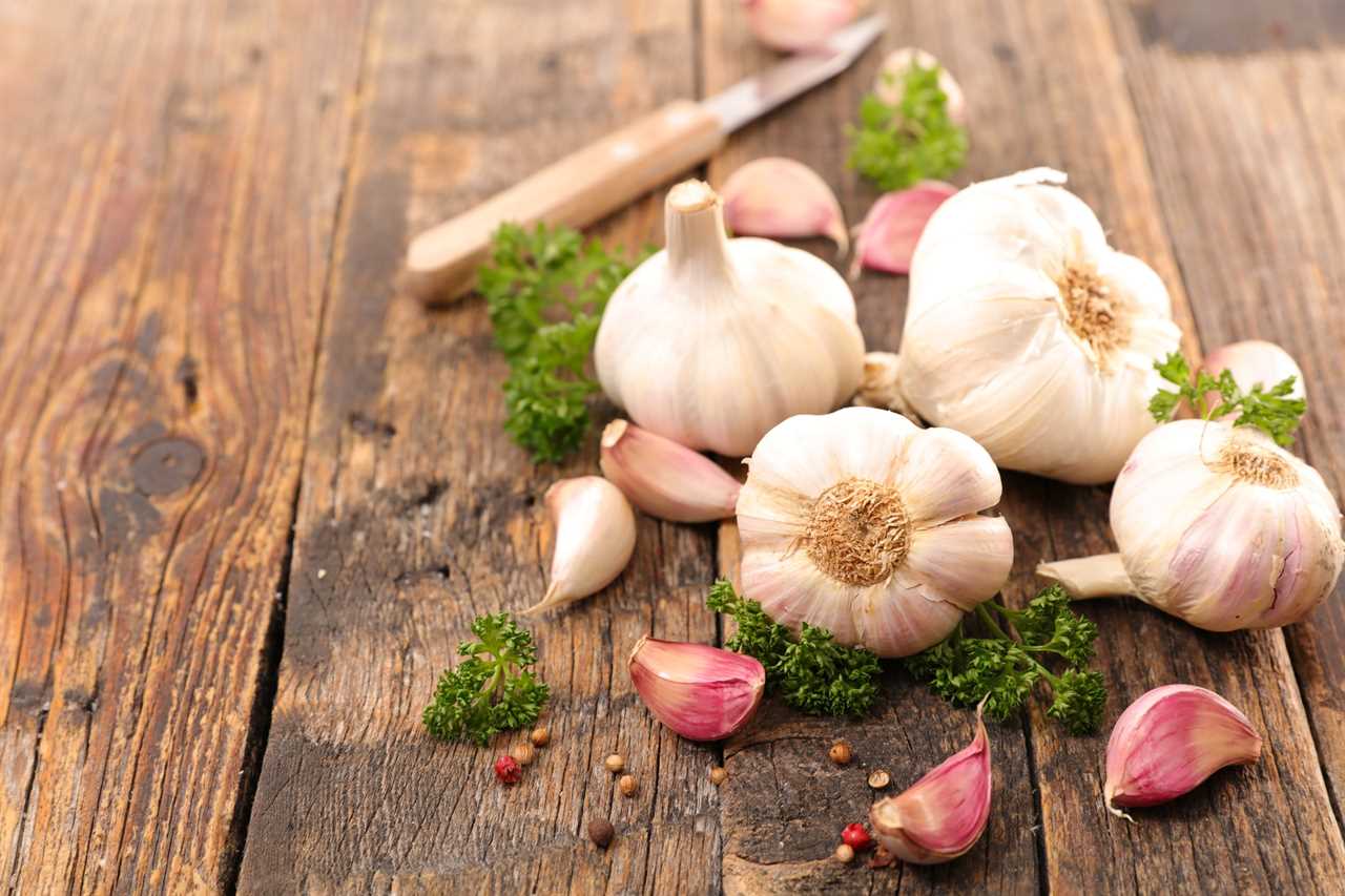 Bulbs of garlic on a wooden table.