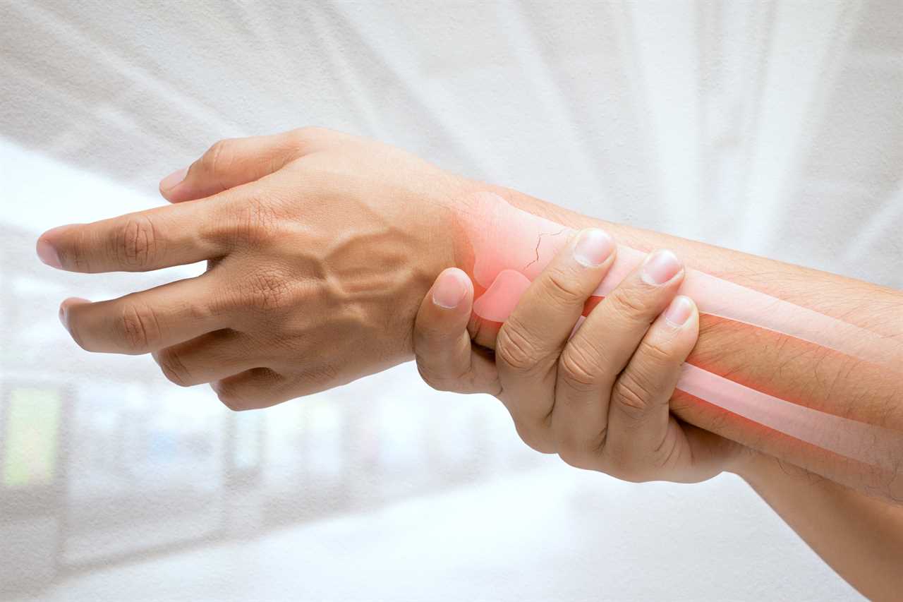 A man massaging painful wrist on a white background.