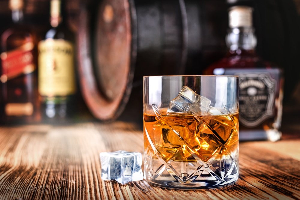 A glass of whiskey on ice.