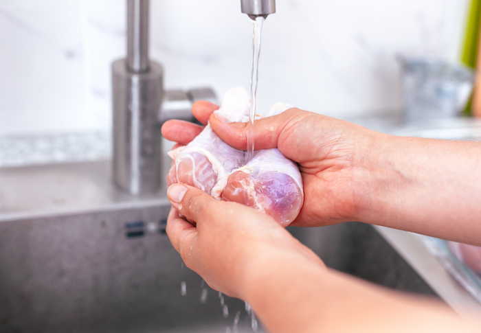 Image of Chicken Being Washed in Sink | Washing Chicken