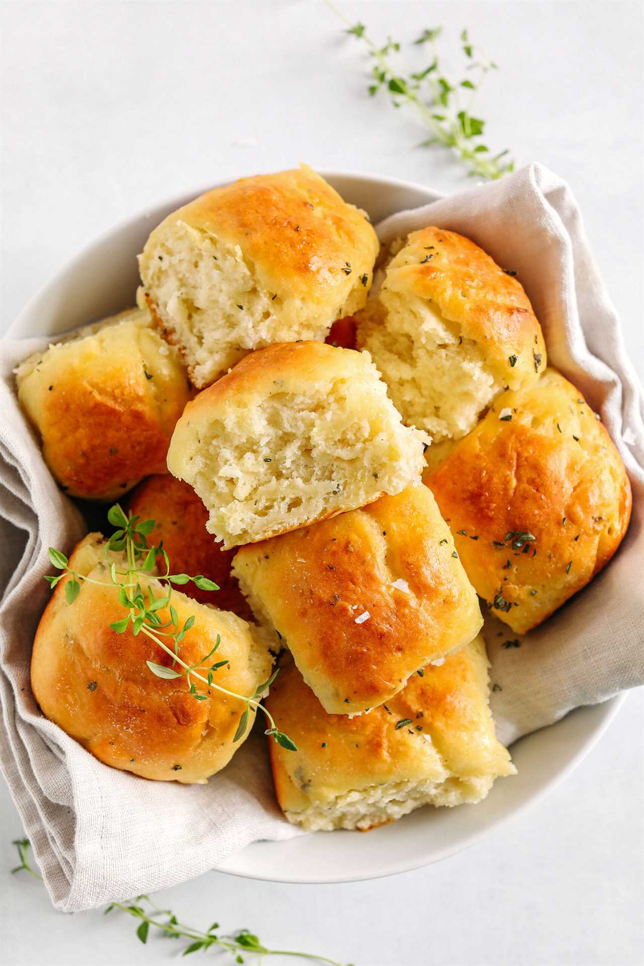 These pull-apart Honey Butter Dinner Rolls are light, fluffy and made without any yeast, eggs or oil. Infused with honey and fresh herbs, these Parker House-style dinner rolls are perfect for your holiday table this season!