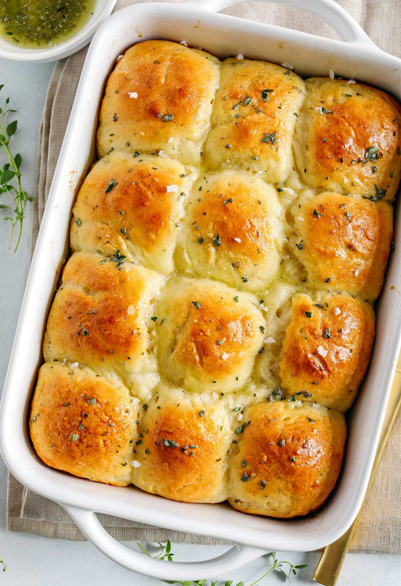 These pull-apart Honey Butter Dinner Rolls are light, fluffy and made without any yeast, eggs or oil. Infused with honey and fresh herbs, these Parker House-style dinner rolls are perfect for your holiday table this season!