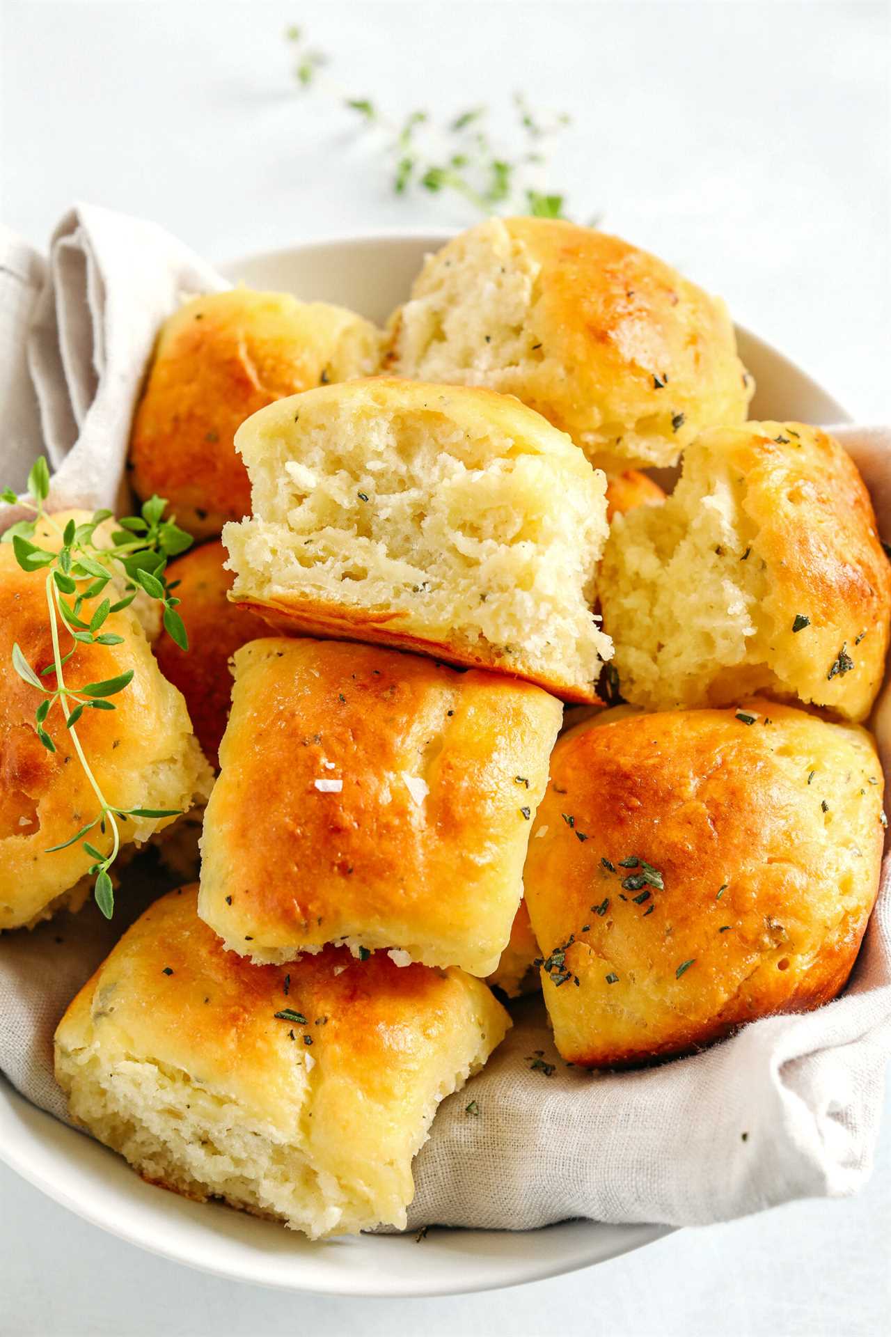 These pull-apart Honey Butter Dinner Rolls are light, fluffy and made without any yeast, eggs or oil. Infused with honey and fresh herbs, these Parker House-style dinner rolls are perfect for your holiday table this season!