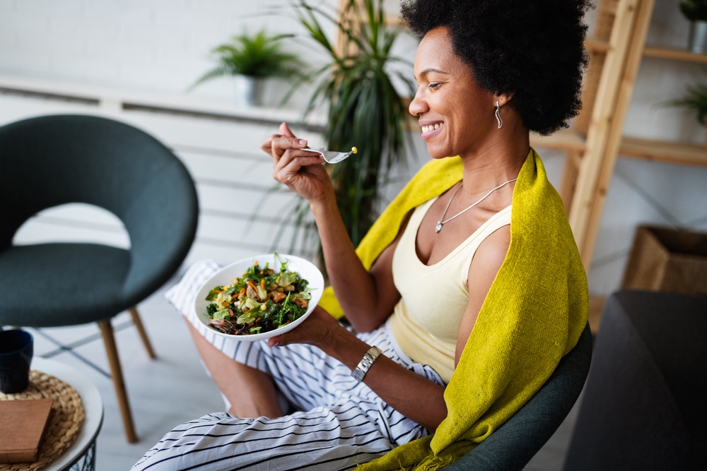 A woman eating a salad.