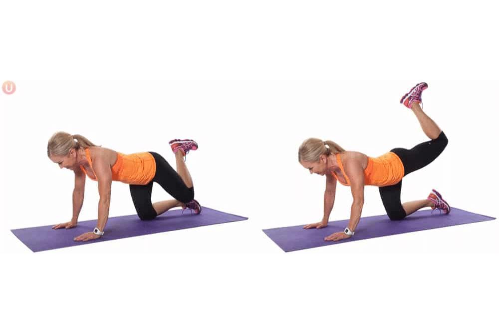 Chris Freytag demonstrating glute kickers on a purple yoga mat.